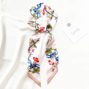 Elegant floral and magpie print long silk scarf twilly on a creamy white background