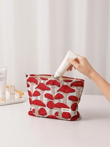 Vintage mushroom jacquard fabric makeup bag with zipper closure shown in hand
