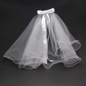 Detail of multi-layered white tulle bridal veil with a satin bow knot on top