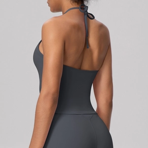 Detail view of charcoal grey halter yoga top showing strappy open back and athletic fabric