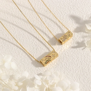Macro detail of rectangle gold moon and star pendant with colorful cubic zirconia