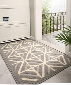 Detail of gray geometric entrance mat with dust-resistant texture and non-slip backing