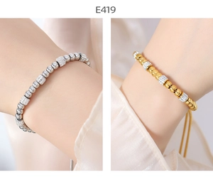 Detail of beaded adjustable bracelets in gold and silver finish with crystal spacers