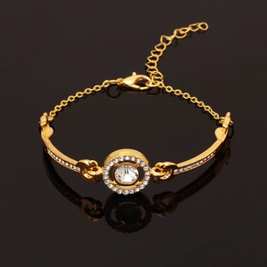 Detail of gold crystal bracelet with large round center stone on black surface