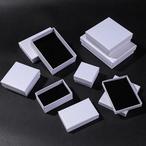 Detailed top view of white textured jewelry gift boxes with contrasting black velvet lining