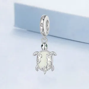 Luminous sea turtle charm in S925 sterling silver with green gem eyes and shell detail