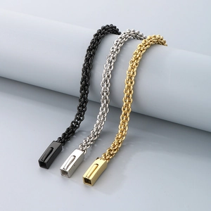 Detail of woven titanium steel bracelets in black, silver and gold with clasp