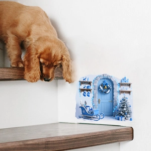 Detailed Christmas door decal with wreath and sled on a white wall by the stairs