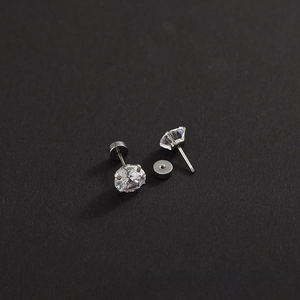 Macro detail of sparkling round zircon stud earrings with threaded safety back design
