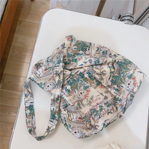 Detail of printed cotton tote bag with traditional landscape art and cross-body strap