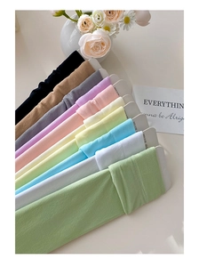 Detail view of 11 pastel-colored velvet socks neatly arranged on a minimal background