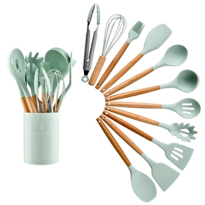 Detailed set of 11 mint green silicone kitchen utensils with natural wooden handles and bucket