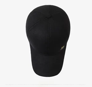 Top down macro view of black wool baseball cap featuring premium gold square logo detail