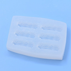 Silicone mold with six slots for creating cream-textured chocolate and fondant cake borders