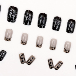Sparkly black star and heart press-on nails set with glitter French tip design