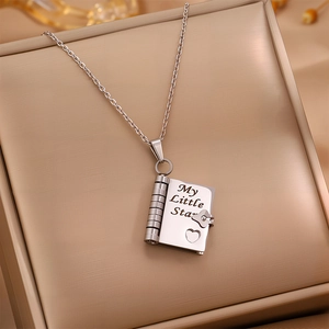 Macro shot of silver envelope locket necklace engraved with My Little Star in a gift box