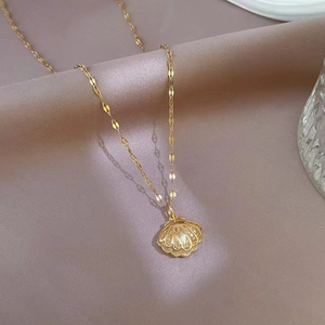 Elegant gold shell pendant necklace with white pearl and sparkling rhinestones