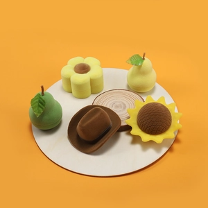 Creative velvet jewelry boxes in pear, flower, and cowboy hat shapes on wood tray