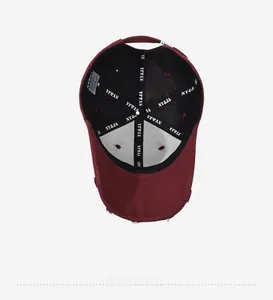 Detailed interior of dark red distressed baseball cap with NY&JA branded inner lining tape