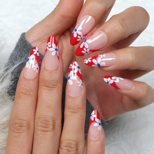 French red almond press-on nails with white flower patterns and glossy finish
