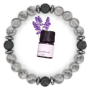 Detail showing lava stone and marble beads diffuser bracelet with a lavender oil vial