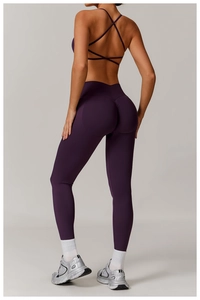 Rear view of purple seamless yoga set with cross back bra and scrunch butt leggings