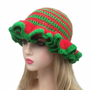 Handmade red and green striped crochet ruffle hat with wavy edge shown on head model