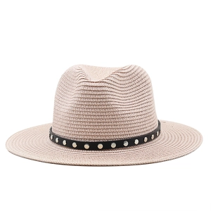 Detail of light beige straw fedora featuring a black leather band with silver metal studs