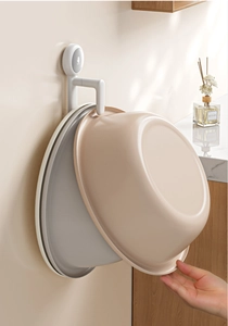 Detail of wall-mounted washbasin hooks showing vertical storage for plastic basins