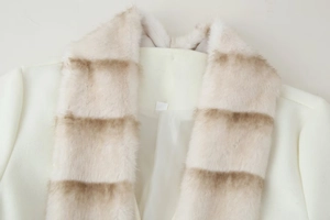 Detail of white wool coat featuring a plush faux fur collar with brown stripes
