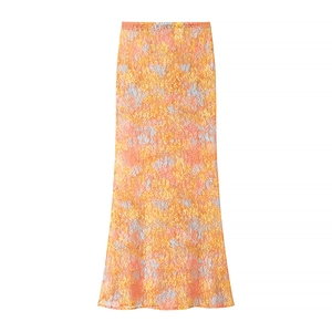 Detail of orange floral lace maxi skirt with slim fit design and intricate patterns