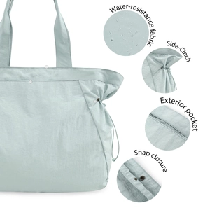 Water-resistant light blue yoga tote bag with side cinches and snap closure detail