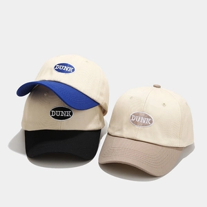 Detailed close-up of cotton baseball caps with DUNK embroidery and contrast brims