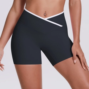 Close-up of high-waisted yoga shorts featuring cross V-waist design and white trim