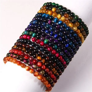 Close-up of 8mm natural stone bead bracelets in rainbow colors on a white display stand