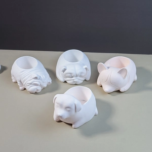 Detailed view of four matte white dog-shaped silicone molds for succulent pots and candles