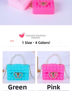Detail of heart-shaped silicone pop purse with pearl handle and metal chain strap