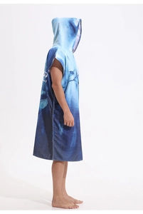 Detail of blue microfiber hooded towel poncho with ocean wave print for beach surfing