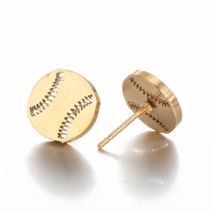 Macro view of gold baseball-shaped stud earrings with realistic stitch textures