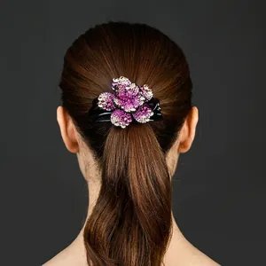 Elegant purple rhinestone flower hair claw clip worn on brunette hair with crystals