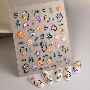 Detail view of 3D embossed floral nail stickers Co-267 with purple flowers and gold accents