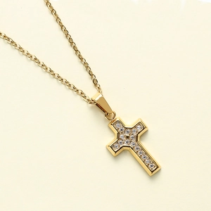 Detailed view of gold cross pendant with shimmering white zircon stones on O-chain
