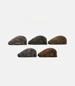 Flat lay of camo newsboy caps in five colors with metal adjustable side buckles