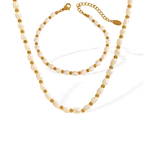 Baroque pearl and gold bead jewelry set with necklace and bracelet on white background