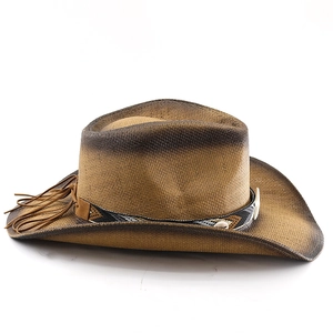 Detail of straw cowboy hat with ethnic band and long brown leather tassels