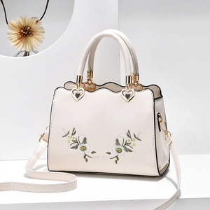 Elegant beige embroidered soft leather tote bag with heart hardware and floral pattern