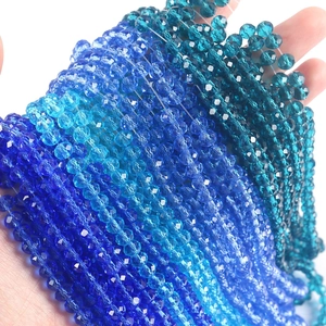 Close-up of faceted crystal glass beads in various shades of blue for DIY jewelry making