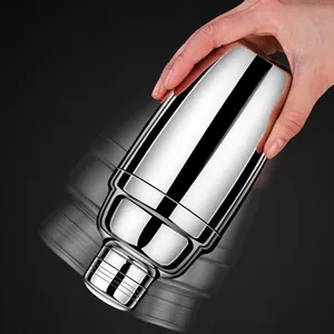 Polished stainless steel cocktail shaker with three-piece leak-proof design in use