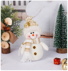 Detail of a plush Christmas snowman ornament featuring white knit fabric and gold stripes