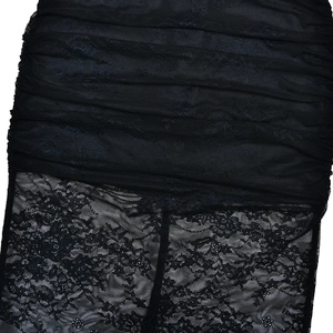 Detail shot of black lace dress showing pleated texture and sheer floral mesh pattern